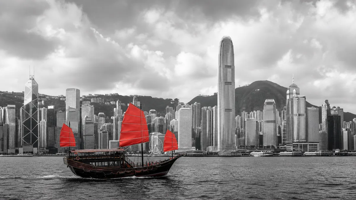 Hong Kong Victoria Harbour skyline at dusk, connecting East and West